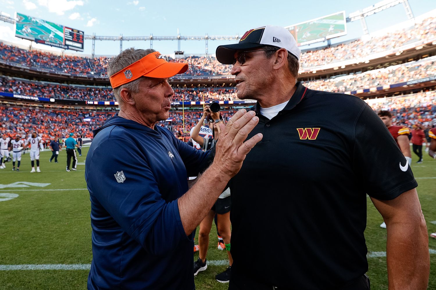 Denver Broncos head coach Sean Payton greets Washington Commanders head coach Ron Rivera after the game at Empower Field at Mile High.